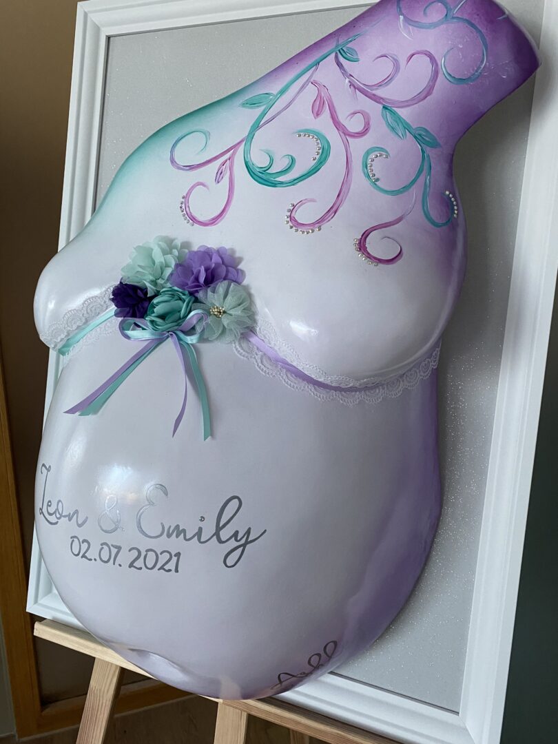 Zwillingsbauch Gipsabdruck mit romantischer Veredelung in Rosa, Lila und Türkis
